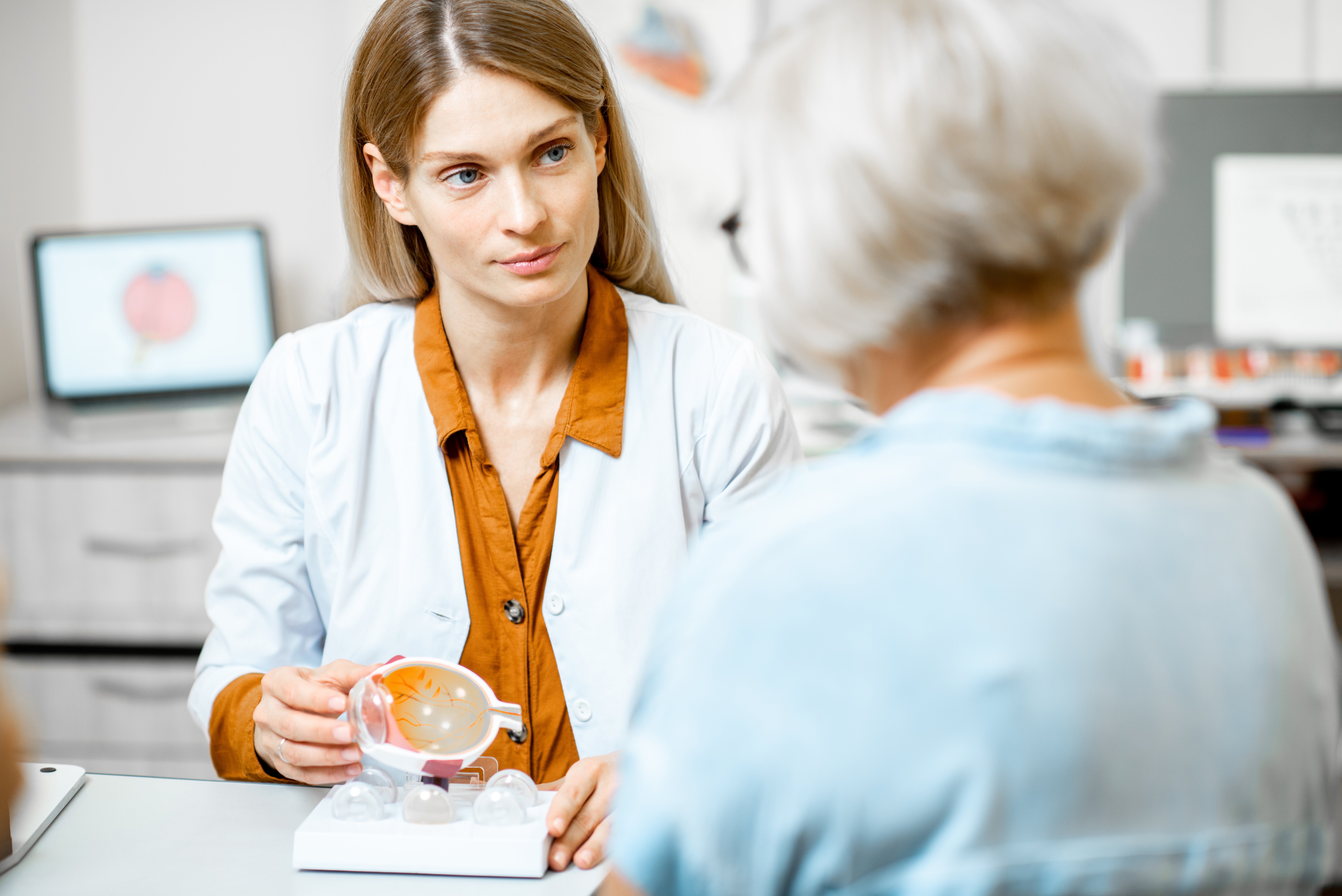 female-european-adult-doctor-hospital-ophthalmologist-showing-eye-model