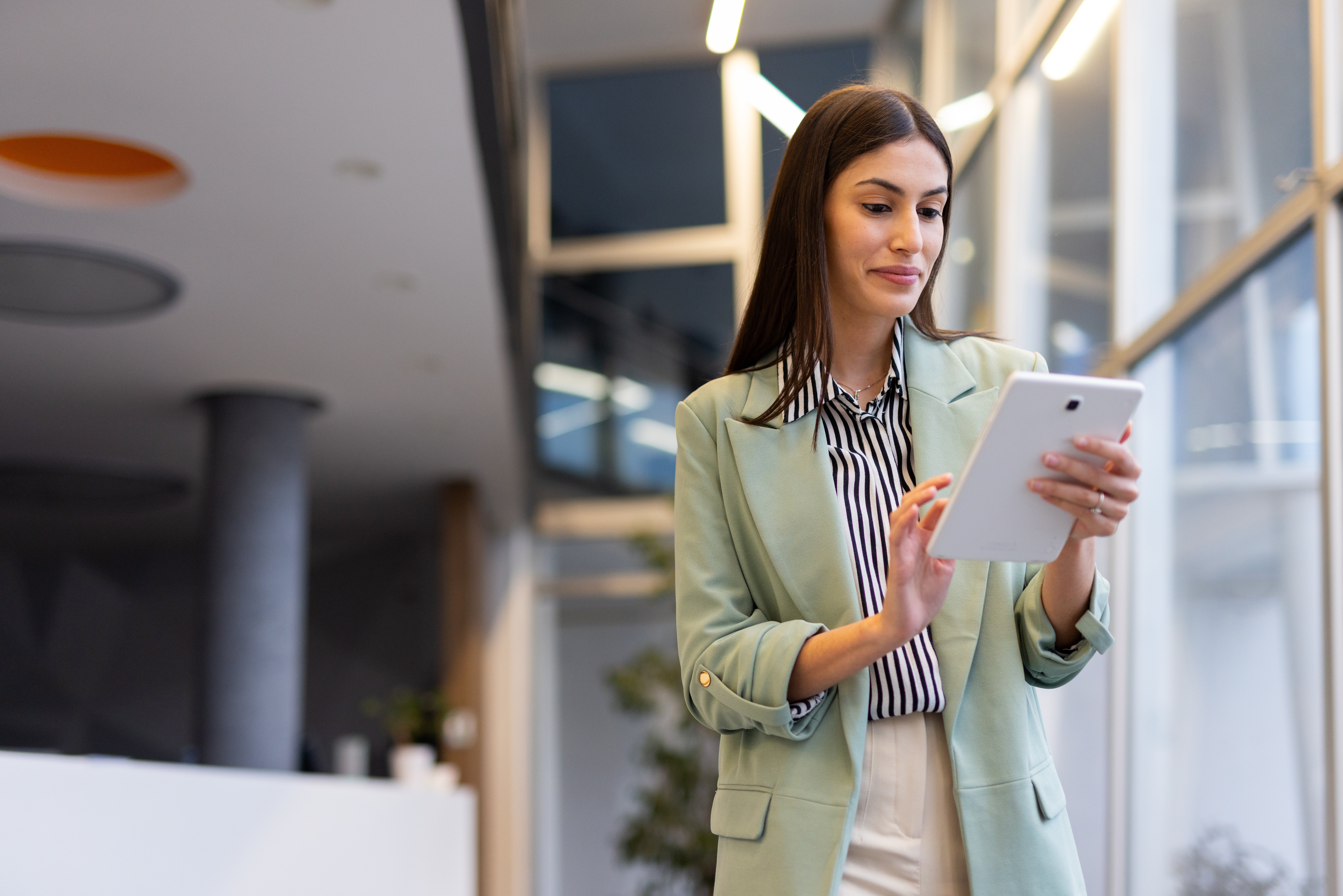 female-european-adult-indoor-reviewing-important-documents-on-a-tablet-web