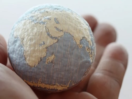 paper world in a hand of a person